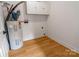 Bright laundry room with wood-look floors and water heater at 940 N New Hope Rd, Gastonia, NC 28054