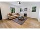 Bright living room featuring a decorative fireplace, hardwood flooring, and natural light from multiple windows at 940 N New Hope Rd, Gastonia, NC 28054
