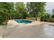 Backyard pool surrounded by a spacious concrete patio and a wooden fence at 940 N New Hope Rd, Gastonia, NC 28054