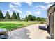 Expansive backyard with a concrete patio, lush green lawn, and a privacy fence at 9814 Tompkins Ln, Waxhaw, NC 28173