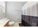 Bright bathroom with a toilet, vanity, and shower with a curtain, offering a functional and clean space at 9814 Tompkins Ln, Waxhaw, NC 28173