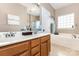 Bathroom showcasing double sinks, large soaking tub, and a walk-in shower at 9814 Tompkins Ln, Waxhaw, NC 28173
