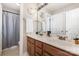 Bathroom features a double sink vanity with framed mirror and tub/shower combination at 9814 Tompkins Ln, Waxhaw, NC 28173