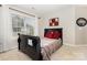 Well-lit bedroom featuring a full bed, bright window, and cozy decor, creating a relaxing and inviting atmosphere at 9814 Tompkins Ln, Waxhaw, NC 28173