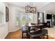 Bright dining area boasts hardwood floors, a modern light fixture, and a door to the outside at 9814 Tompkins Ln, Waxhaw, NC 28173