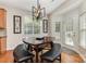 Bright dining area with a stylish light fixture, wood floors, and access to the backyard at 9814 Tompkins Ln, Waxhaw, NC 28173