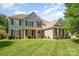 Beautiful exterior elevation view featuring a two-story home with manicured lawn and mature trees at 9814 Tompkins Ln, Waxhaw, NC 28173