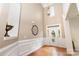 The home's foyer features hardwood floors, soaring ceilings, elegant wainscoting, and a decorative light fixture at 9814 Tompkins Ln, Waxhaw, NC 28173