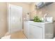 Laundry room with washer and dryer, overhead storage, and tile flooring at 9814 Tompkins Ln, Waxhaw, NC 28173