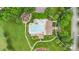 Aerial view of a community pool, playground, and clubhouse surrounded by manicured lawns and mature trees at 9814 Tompkins Ln, Waxhaw, NC 28173