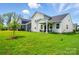 Spacious backyard with lush green grass and a covered patio at 9842 Quercus Ln, Huntersville, NC 28078