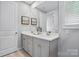 Bathroom with gray cabinets, double sinks, quartz countertop, and modern fixtures at 9842 Quercus Ln, Huntersville, NC 28078