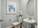 Elegant powder room featuring a pedestal sink and tasteful decor at 9842 Quercus Ln, Huntersville, NC 28078