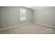 Bedroom with neutral walls, carpet and a large window providing natural light at 9842 Quercus Ln, Huntersville, NC 28078