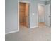 Neutral bedroom with carpet and trim showcasing the walk-in closet with hanging metal shelving at 9842 Quercus Ln, Huntersville, NC 28078