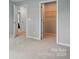 Neutral bedroom with carpet and trim showcasing the walk-in closet with hanging metal shelving at 9842 Quercus Ln, Huntersville, NC 28078