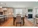 Open-concept dining area with a view of the kitchen and a cozy living room fireplace at 9842 Quercus Ln, Huntersville, NC 28078