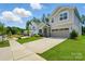 Landscaped front yard leading to this traditional home boasting a stone entryway, sidewalk, and driveway at 9842 Quercus Ln, Huntersville, NC 28078