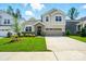 Charming two-story home featuring a stone accent entryway, well-manicured lawn, and a two car garage at 9842 Quercus Ln, Huntersville, NC 28078