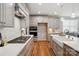 Modern kitchen features stainless appliances, large island, quartz countertops, and hardwood floors at 9842 Quercus Ln, Huntersville, NC 28078