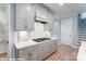 Modern kitchen features gray cabinetry, stainless steel appliances, herringbone backsplash, and sleek countertops at 9842 Quercus Ln, Huntersville, NC 28078