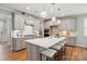 An open kitchen area featuring stainless steel appliances, quartz countertops, and a large center island at 9842 Quercus Ln, Huntersville, NC 28078