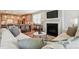 Cozy living room showcasing fireplace with television, open to kitchen and dining areas at 9842 Quercus Ln, Huntersville, NC 28078