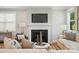 Inviting living room with a fireplace, comfortable seating, and natural light at 9842 Quercus Ln, Huntersville, NC 28078