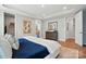 Bright main bedroom featuring tray ceiling, wood floors, and a walk-in closet at 9842 Quercus Ln, Huntersville, NC 28078