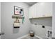 Mud room with gray walls, hooks, storage cabinets, and tile floors at 9842 Quercus Ln, Huntersville, NC 28078