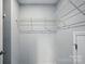 Spacious walk-in closet features metal shelving around the perimeter for optimal storage at 9842 Quercus Ln, Huntersville, NC 28078