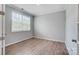 A cozy bedroom featuring light gray walls, wood floors and natural light from a bright window at 9934 Cask Way, Huntersville, NC 28078