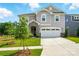 Charming two-story home boasts a two-car garage, stone accents, manicured lawn, and inviting curb appeal at 9934 Cask Way, Huntersville, NC 28078