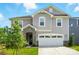 Charming two-story home boasts a two-car garage, stone accents, manicured lawn, and inviting curb appeal at 9934 Cask Way, Huntersville, NC 28078