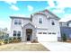 Charming two-story home with a stone-accented entryway and a two-car garage showcasing curb appeal at 9934 Cask Way, Huntersville, NC 28078