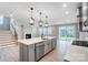 Open concept kitchen with gray cabinetry, stainless appliances and access to outdoor living at 9934 Cask Way, Huntersville, NC 28078