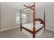 Neutral bedroom with four-poster bed, ceiling fan and lots of natural light at 10304 Squires Way # 18, Cornelius, NC 28031