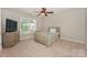 Comfortable bedroom showcasing neutral tones, carpet and a ceiling fan at 10304 Squires Way # 18, Cornelius, NC 28031