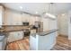 Well-lit kitchen with white cabinetry, stainless steel appliances, and hardwood floors at 10304 Squires Way # 18, Cornelius, NC 28031