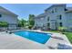 Beautiful backyard with an in-ground pool, landscaped yard, white picket fence, and back of a two-story home at 10304 Squires Way # 18, Cornelius, NC 28031