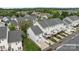 An aerial view shows a row of townhomes with well-manicured lawns at 10455 Alexander Martin Ave, Charlotte, NC 28277