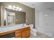 Bathroom featuring a vanity with storage and a shower-tub combination at 10455 Alexander Martin Ave, Charlotte, NC 28277