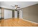 This is a bedroom with hardwood floors, a ceiling fan and a double closet at 10455 Alexander Martin Ave, Charlotte, NC 28277