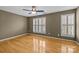 Comfortable bedroom with hardwood floors, ceiling fan and windows with plantation shutters at 10455 Alexander Martin Ave, Charlotte, NC 28277