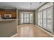 Bright dining area featuring tile flooring, large windows, and a modern light fixture at 10455 Alexander Martin Ave, Charlotte, NC 28277