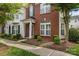 Charming brick facade townhome with manicured landscaping and a covered entryway at 10455 Alexander Martin Ave, Charlotte, NC 28277