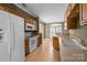 Bright kitchen with tile floors, wooden cabinets, and modern white appliances at 10455 Alexander Martin Ave, Charlotte, NC 28277