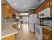 Well-lit kitchen with wooden cabinetry and a view into the living area at 10455 Alexander Martin Ave, Charlotte, NC 28277