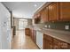 Spacious kitchen with tile flooring, wooden cabinets, and modern appliances at 10455 Alexander Martin Ave, Charlotte, NC 28277
