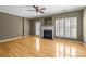 Inviting living room features a fireplace, hardwood floors, and bright windows with great natural light at 10455 Alexander Martin Ave, Charlotte, NC 28277